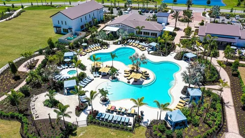 an aerial view of a house with a swimming pool yard and outdoor seating