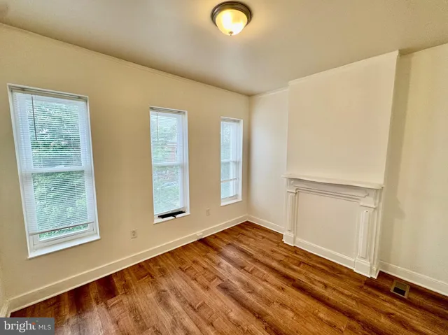 a bathroom with a sink a toilet and a window
