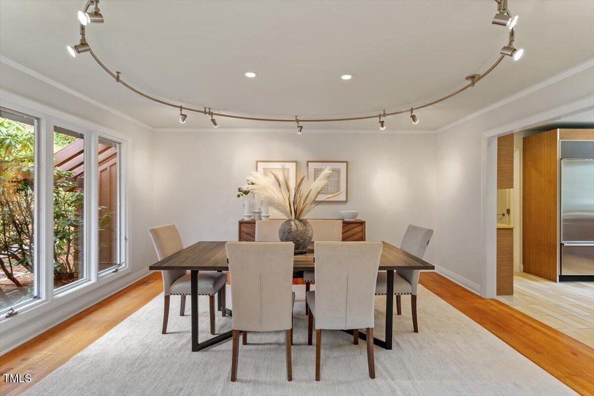 10729 Trego Trail Raleigh, NC 27614 - Photo 12 of 65 a view of a dining room with furniture window and wooden floor