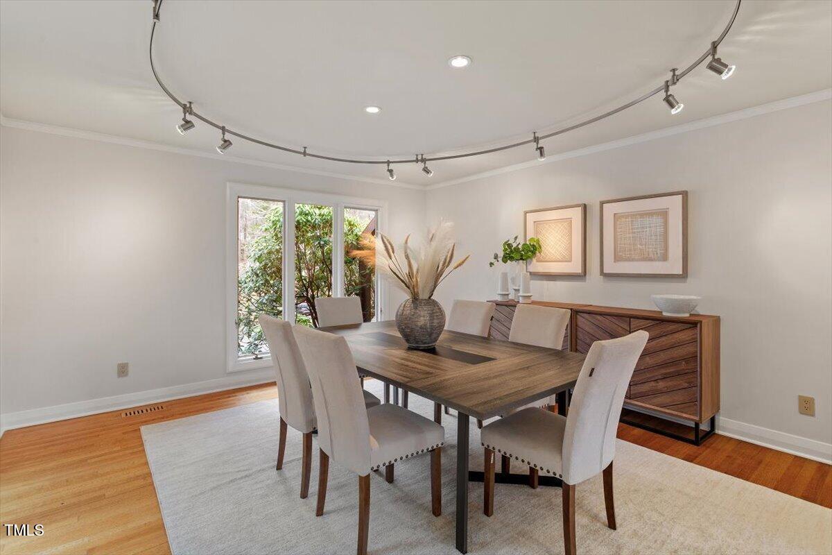 10729 Trego Trail Raleigh, NC 27614 - Photo 13 of 65 a view of a dining room with furniture window and wooden floor