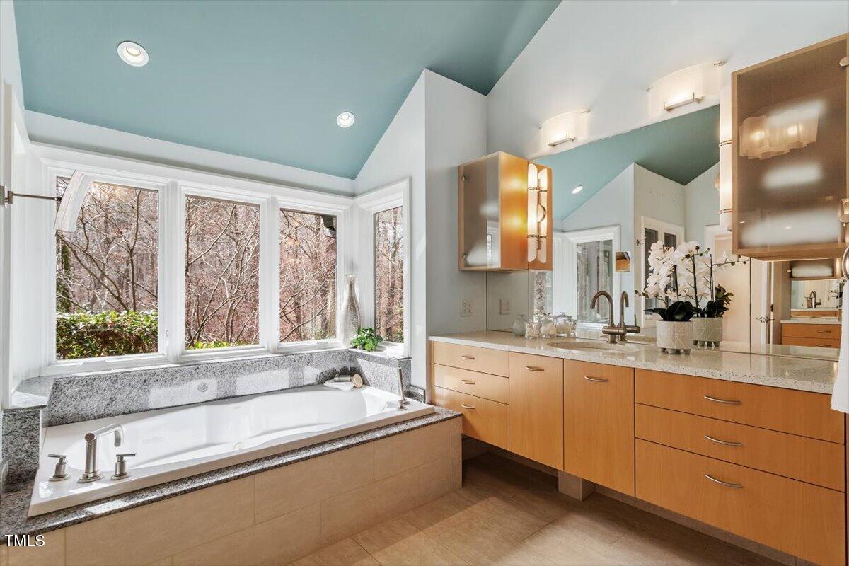 10729 Trego Trail Raleigh, NC 27614 - Photo 25 of 65 a large kitchen with kitchen island a large window a sink and cabinets