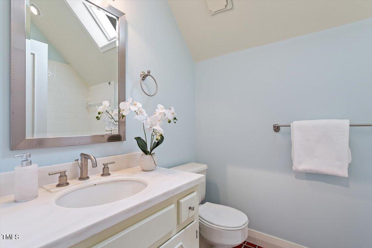 10729 Trego Trail Raleigh, NC 27614 - Photo 36 of 65 a bathroom with a granite countertop sink a toilet and a mirror