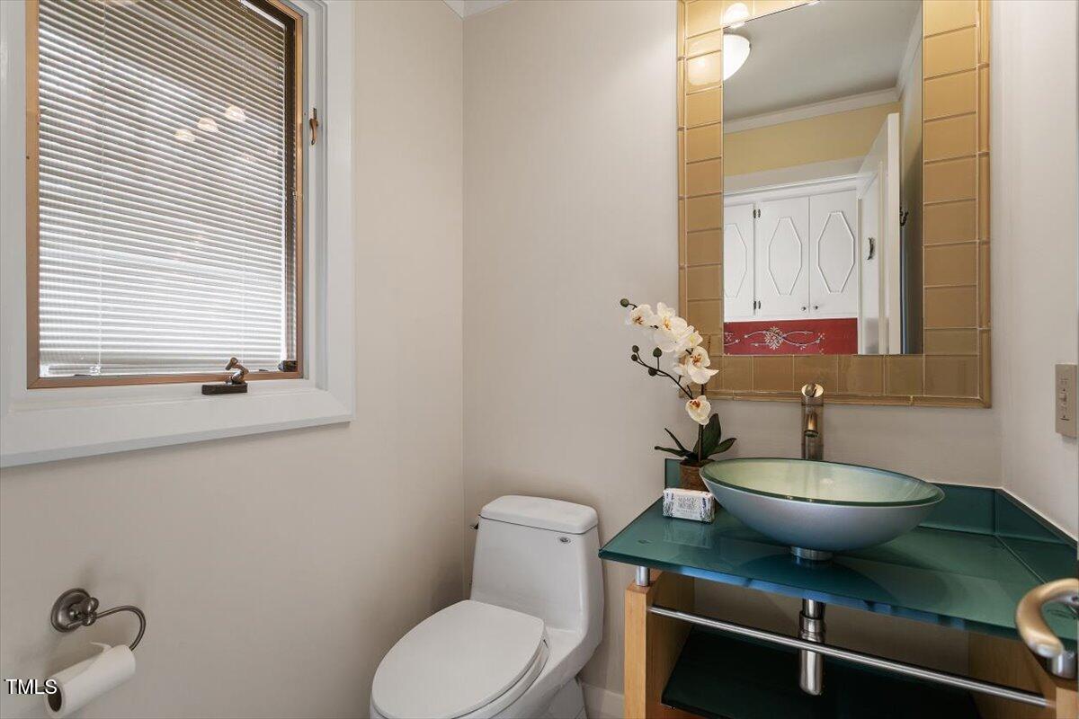 10729 Trego Trail Raleigh, NC 27614 - Photo 37 of 65 a bathroom with a toilet a sink and mirror