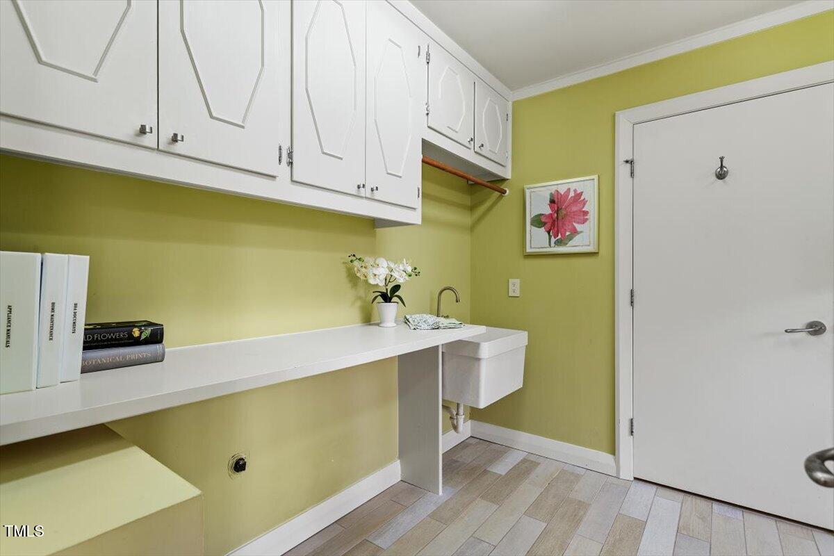 10729 Trego Trail Raleigh, NC 27614 - Photo 38 of 65 a room with cabinets and wooden floor