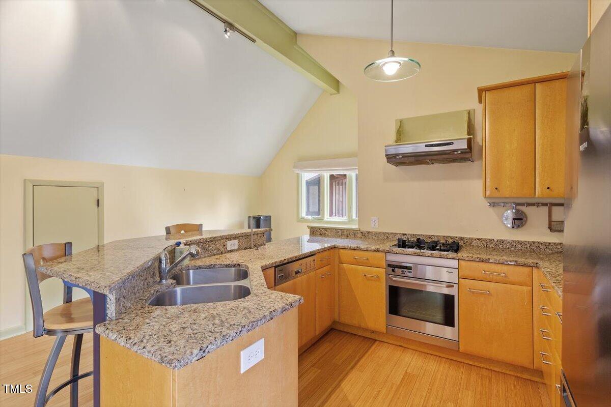 10729 Trego Trail Raleigh, NC 27614 - Photo 43 of 65 a kitchen with stainless steel appliances granite countertop a sink stove and refrigerator