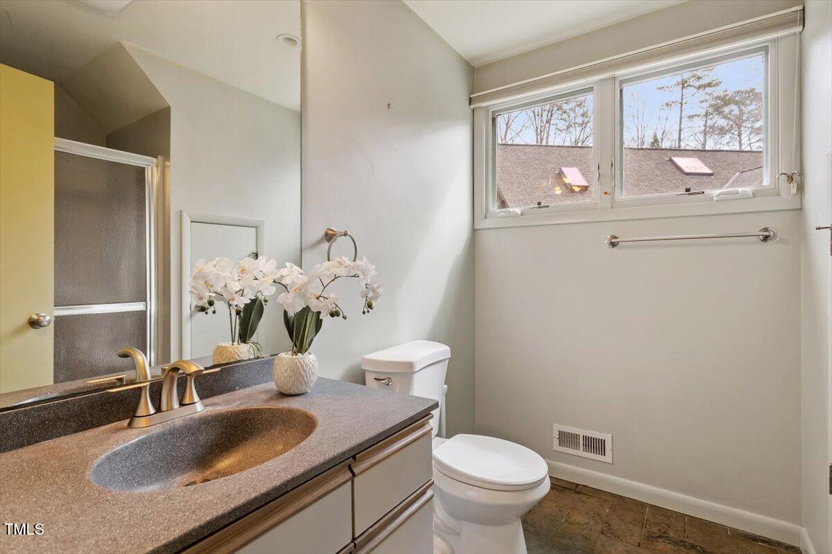 10729 Trego Trail Raleigh, NC 27614 - Photo 45 of 65 a bathroom with a granite countertop sink mirror and toilet