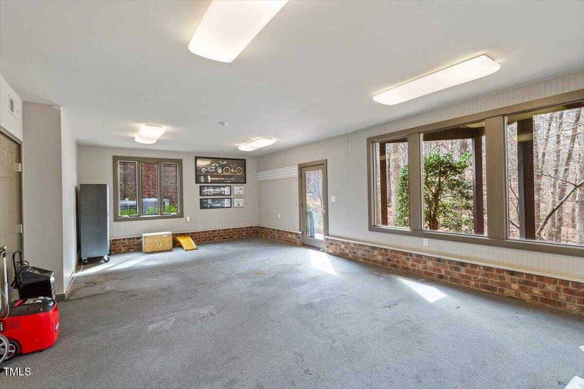 10729 Trego Trail Raleigh, NC 27614 - Photo 47 of 65 an empty room with floor to ceiling window and an outdoor view