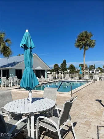 a view of yard with swimming pool and green space
