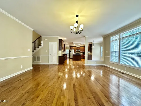 a view of a livingroom with furniture a ceiling fan and window