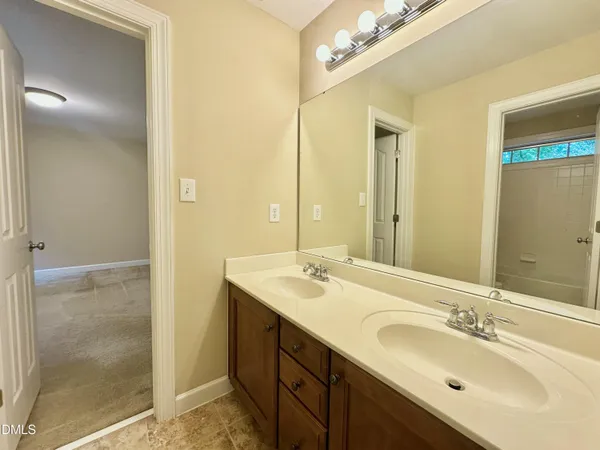 a white toilet and tub sitting next to a bathroom sink