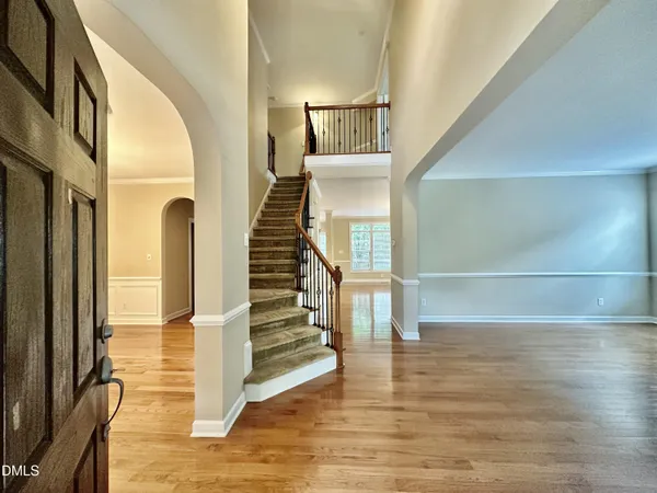 a view of entryway and hall with wooden floor