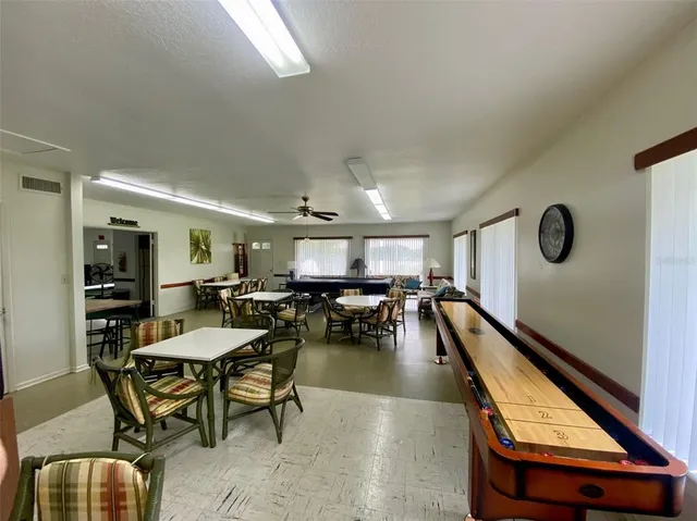 a room with furniture pool table table and chairs