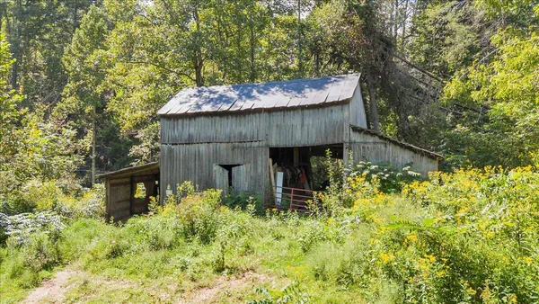 a view of a wooden house with a tree