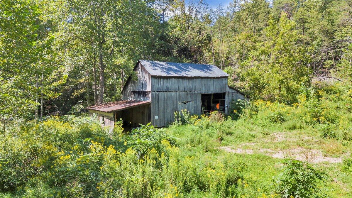 5741 Providence Church Road Ferrum, VA 24088 - Photo 31 of 52 a view of a wooden house with a tree