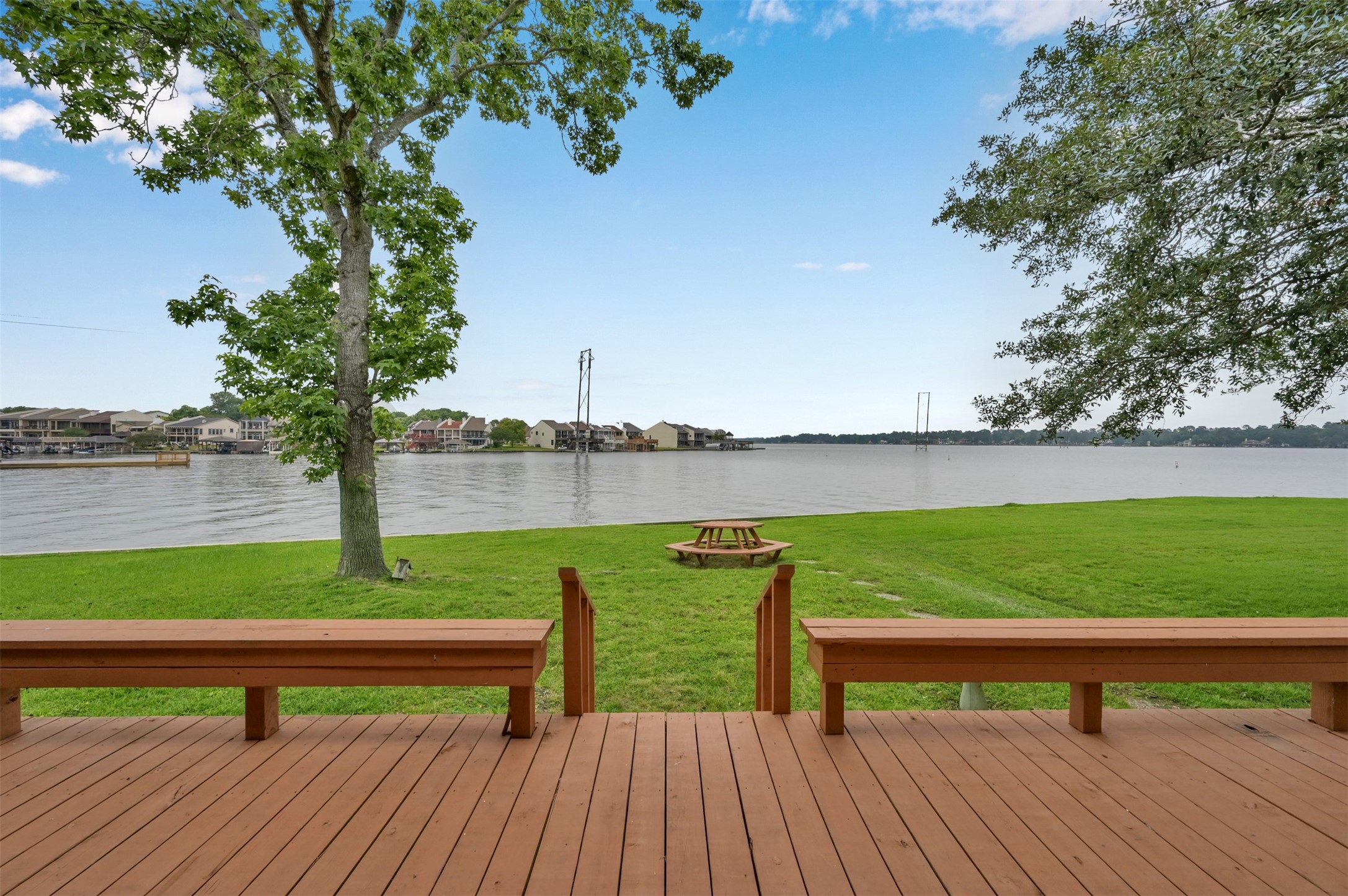 124 April Point Drive North Montgomery, TX 77356 - Photo 1 of 26 a view of a lake with a bench and a bench