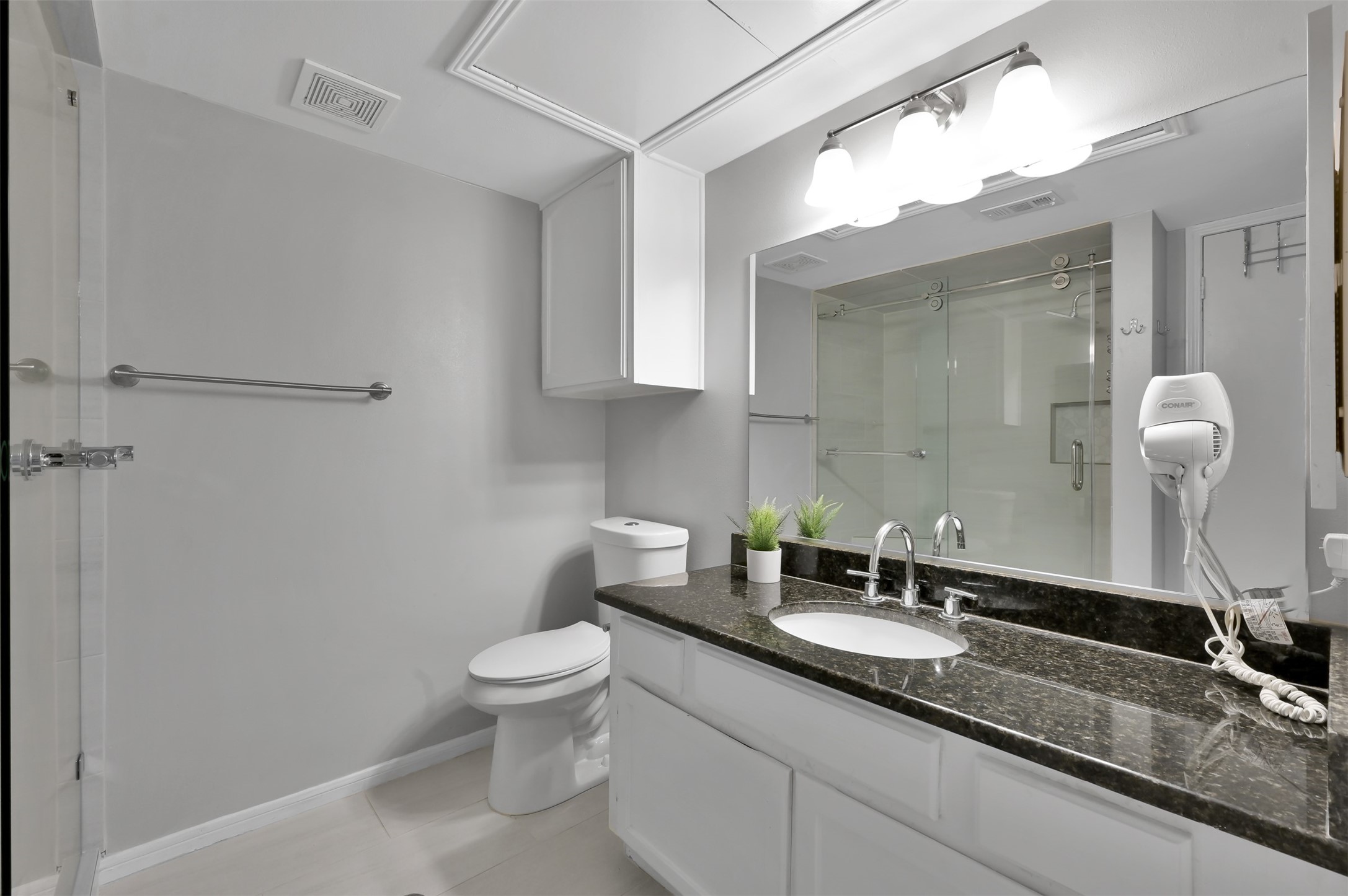 124 April Point Drive North Montgomery, TX 77356 - Photo 19 of 26 a bathroom with a granite countertop sink a toilet and a mirror