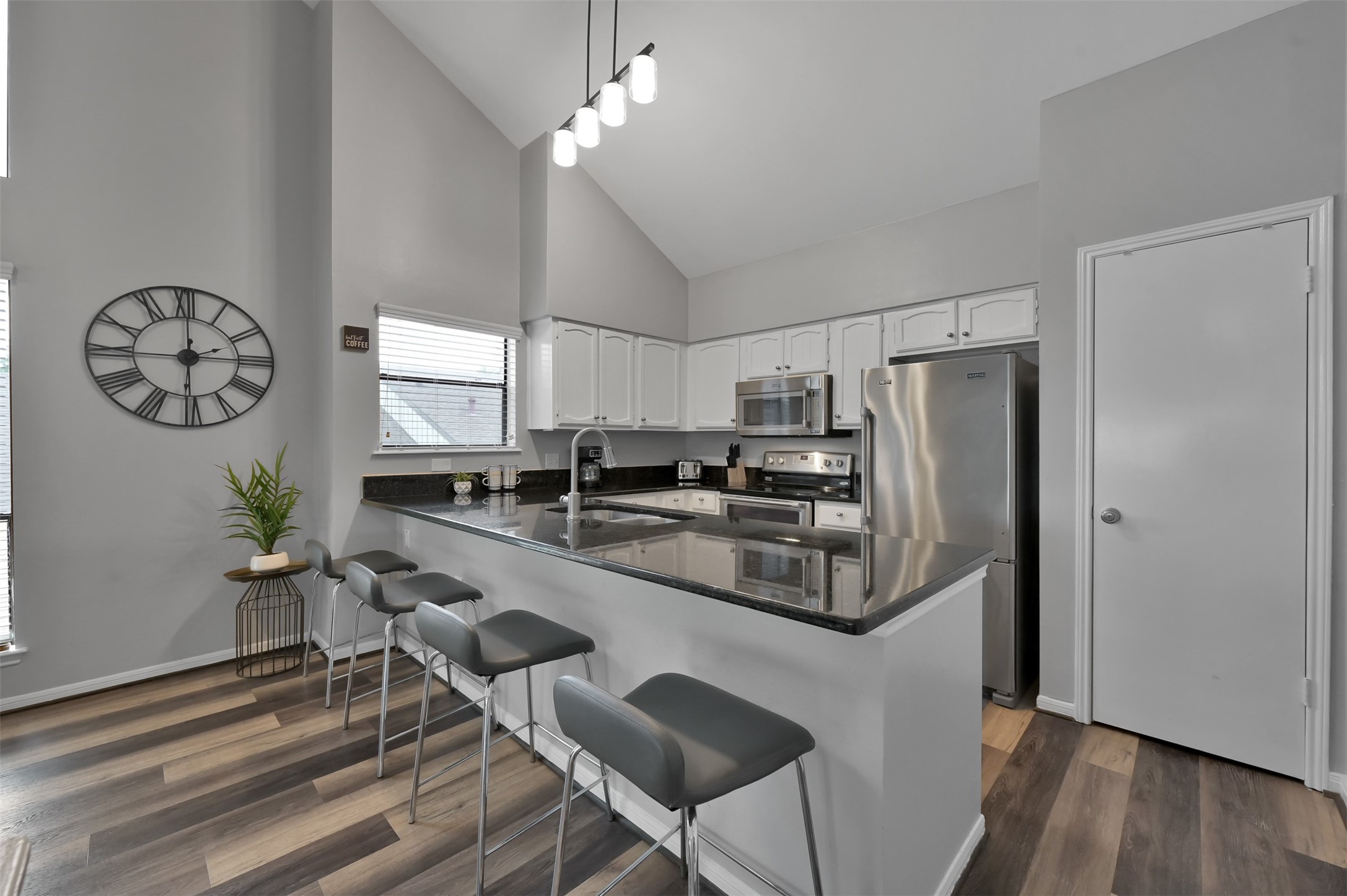 124 April Point Drive North Montgomery, TX 77356 - Photo 9 of 26 a kitchen with stainless steel appliances a table chairs and a window