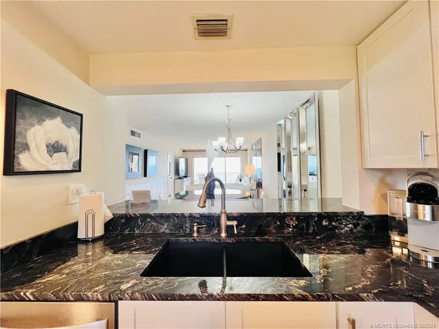 a living room with furniture and large windows