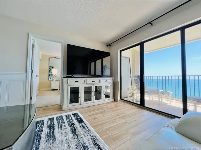 a bedroom with a large bed and a potted plant