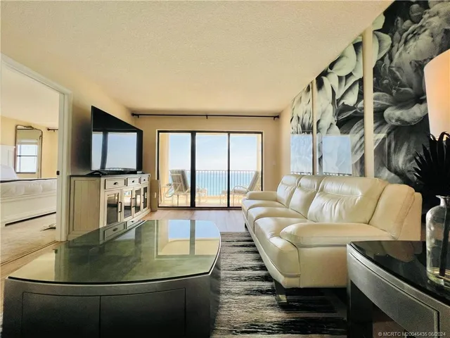 a bedroom with a bed and a flat tv screen on dresser