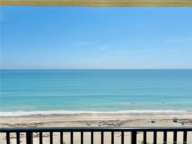a bathroom with a granite countertop toilet and a shower