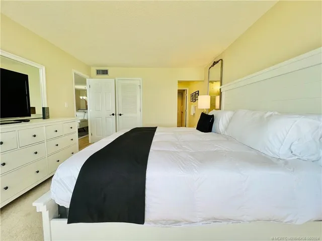 a bedroom with a bed and a lamp