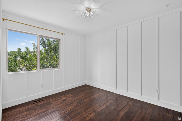 2223 North Pointe Meadow Loop Lehi, UT 84048 - Photo 20 of 56 Room featuring rich wood-finish flooring, white paneled walls, and a large window