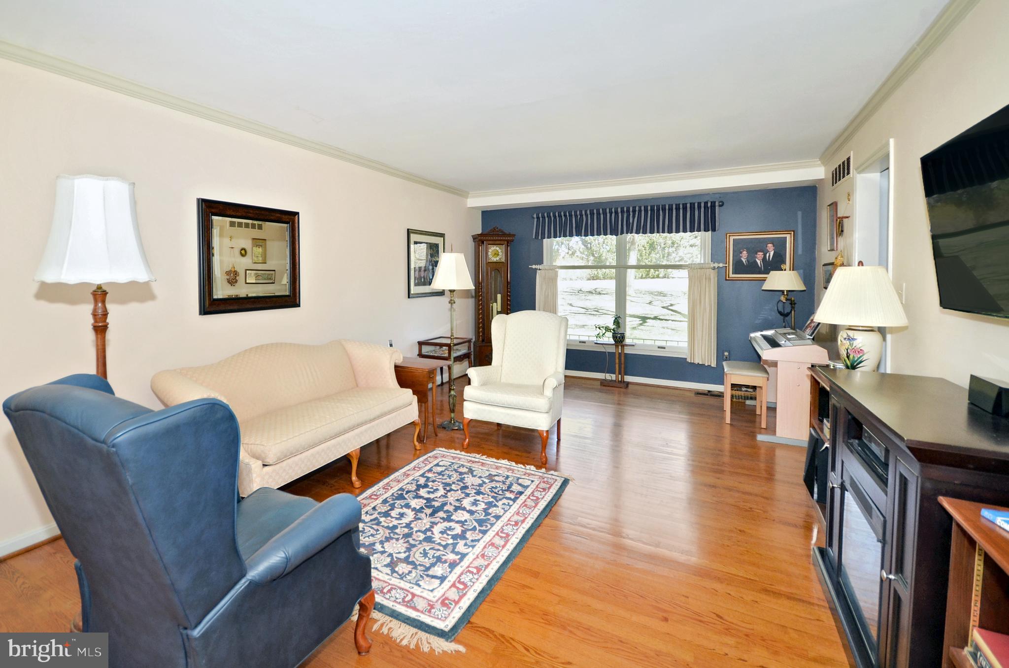 12917 Gent Road Reisterstown, MD 21136 - Photo 12 of 37 Living room with crown molding & hardwood floors