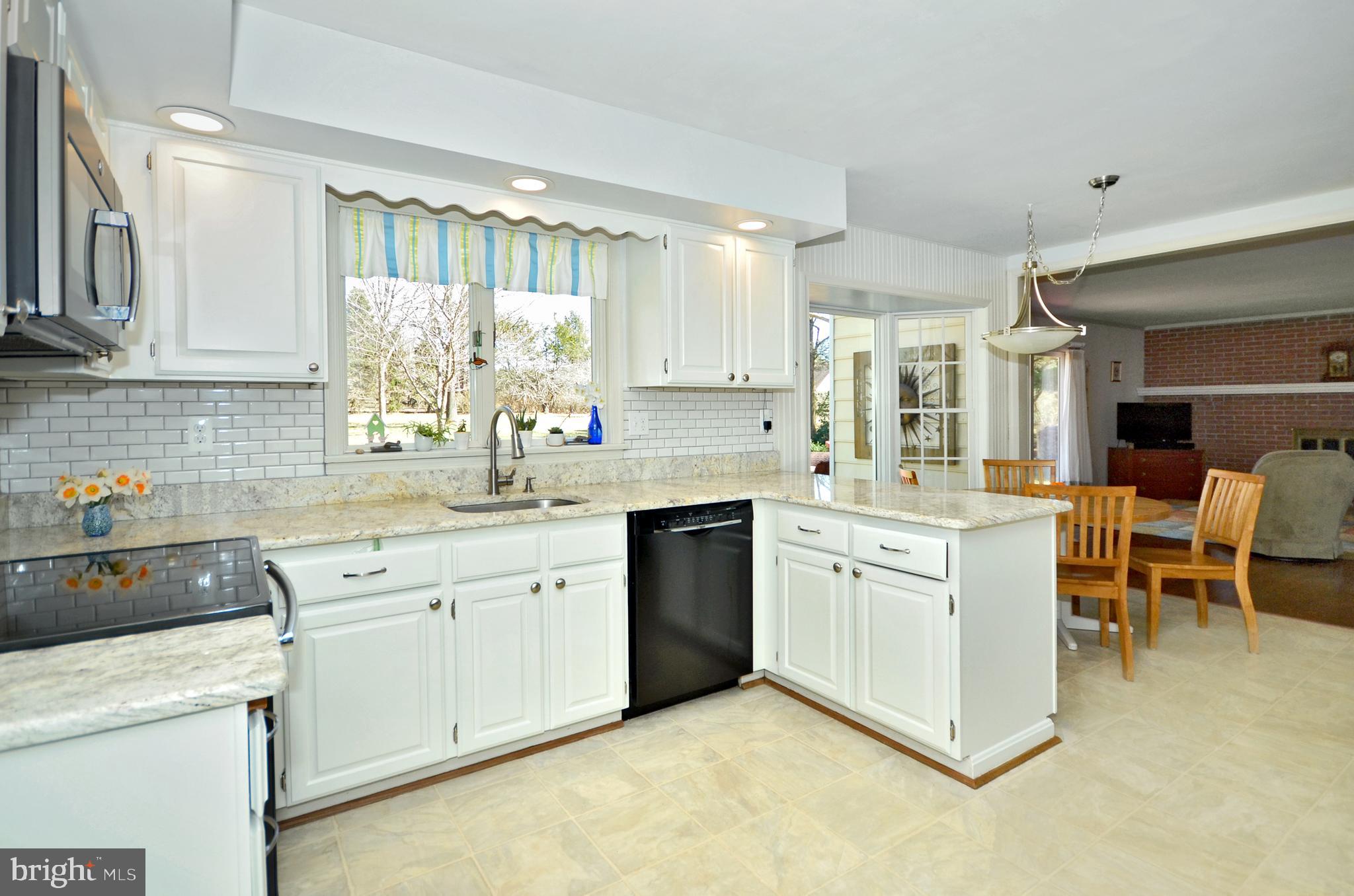 Eat-in kitchen with granite countertops.