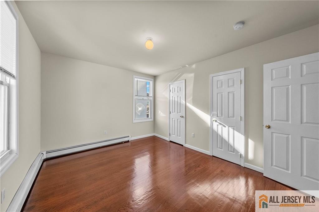 2102 Woodbridge Avenue, Unit 2 Edison, NJ 08817 - Photo 11 of 19 a view of an empty room with wooden floor