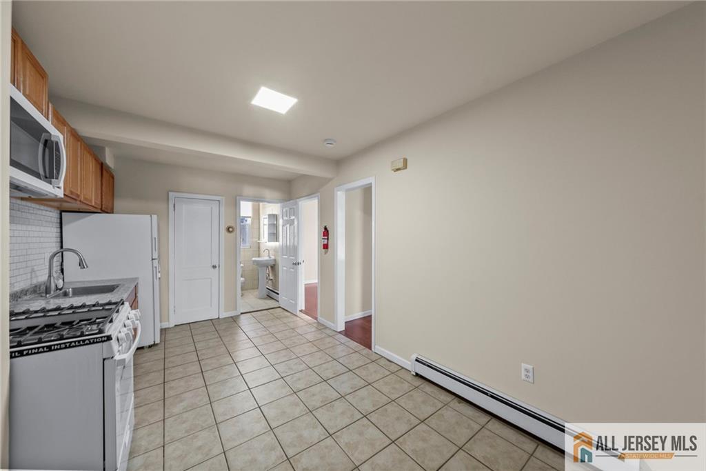 2102 Woodbridge Avenue, Unit 2 Edison, NJ 08817 - Photo 14 of 19 a view of a kitchen with storage and utility