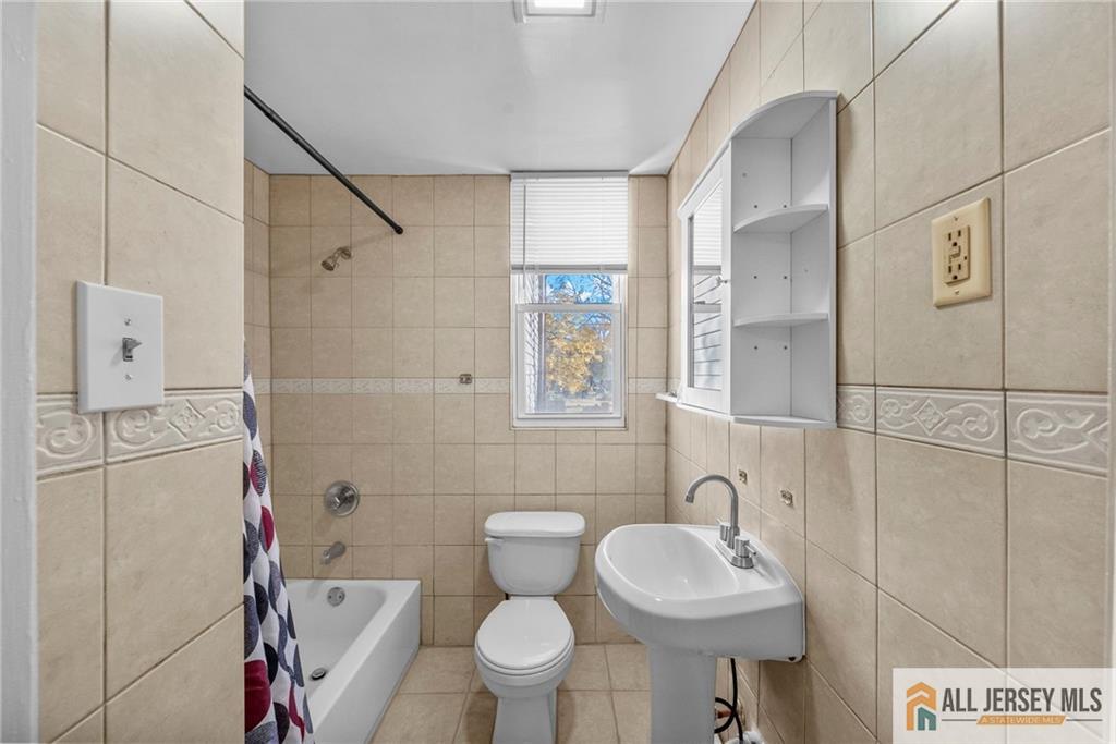 2102 Woodbridge Avenue, Unit 2 Edison, NJ 08817 - Photo 5 of 19 a bathroom with a sink toilet and shower