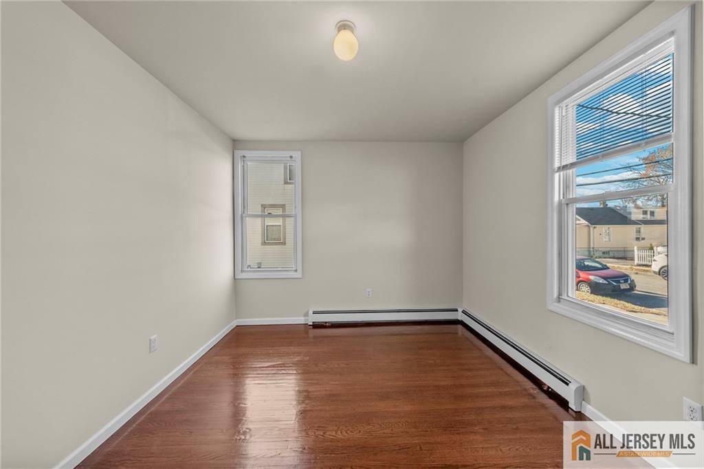 2102 Woodbridge Avenue, Unit 2 Edison, NJ 08817 - Photo 8 of 19 a view of a room with wooden floor and window