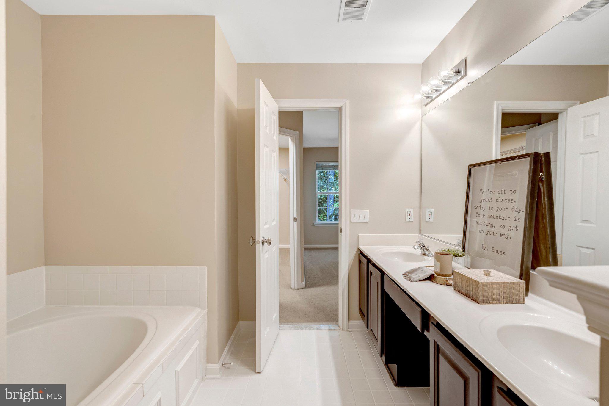 7706 Shadowcreek Terrace Springfield, VA 22153 - Photo 17 of 30 a bathroom with a bathtub sink and mirror