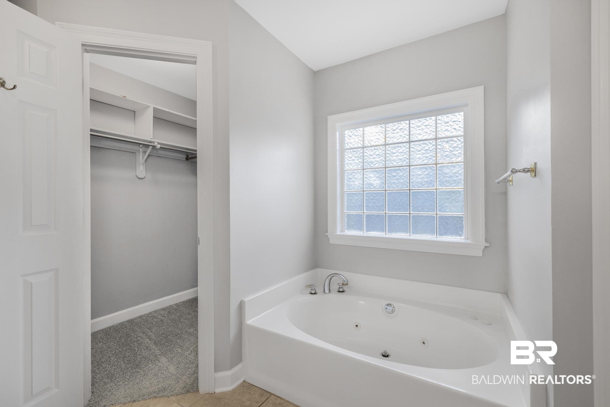 8077 Hooks Road Bay Minette, AL 36507 - Photo 29 of 48 Full bath featuring a walk in closet, a jetted tub, light carpet, and light tile patterned floors