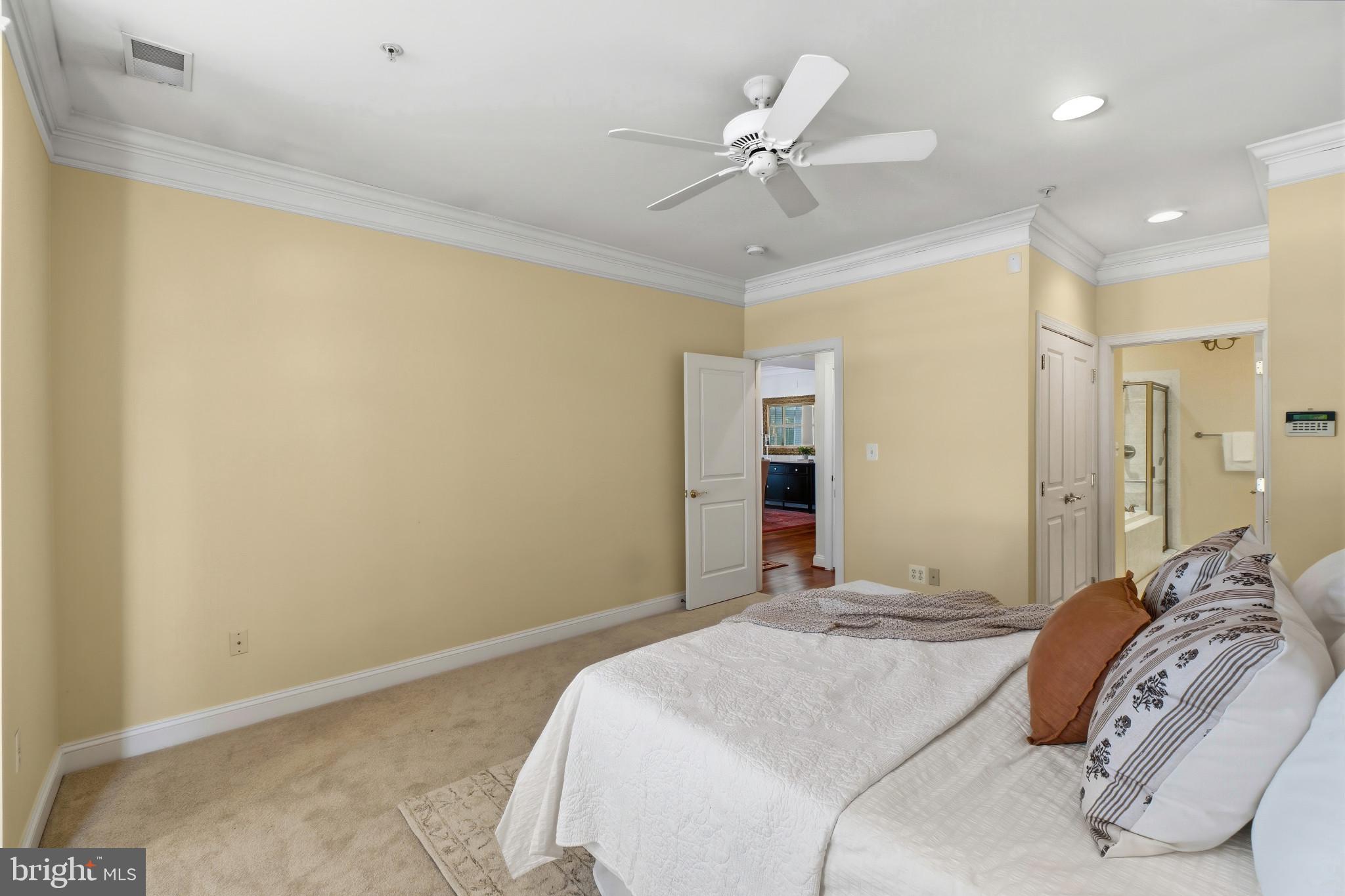 2607 Buckingham Road, Unit 78 Ellicott City, MD 21043 - Photo 16 of 43 a bedroom with a large bed and a chandelier