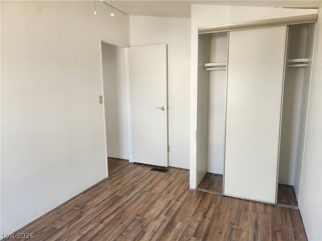 3189 Del Monte Street Laughlin, NV 89029 - Photo 21 of 32 Well-maintained flooring and a functional closet define this comfortable bedroom space.