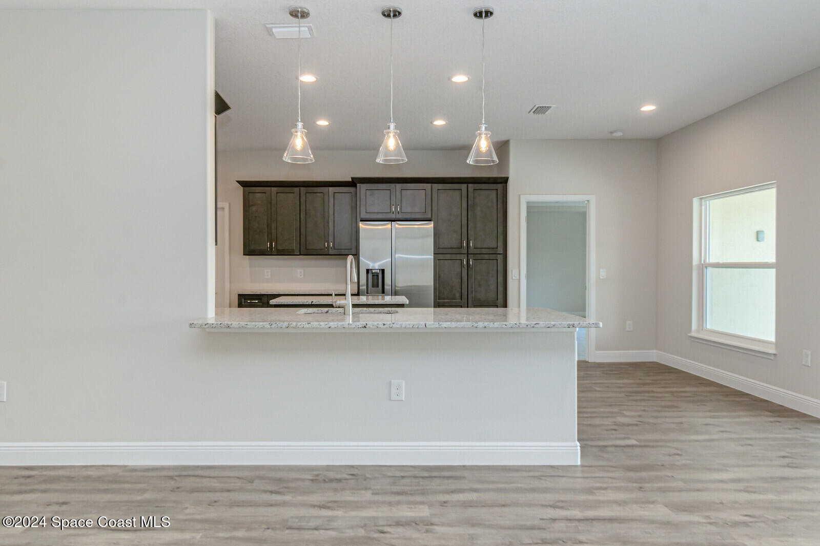 347 Trilby Road Southwest Palm Bay, FL 32908 - Photo 3 of 9 a view of kitchen with microwave and refrigerator
