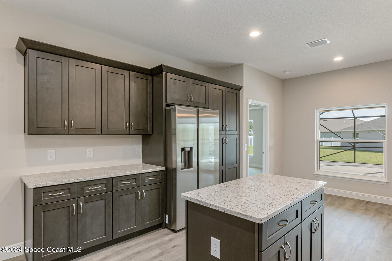 347 Trilby Road Southwest Palm Bay, FL 32908 - Photo 4 of 9 a kitchen with a sink a cabinets and window
