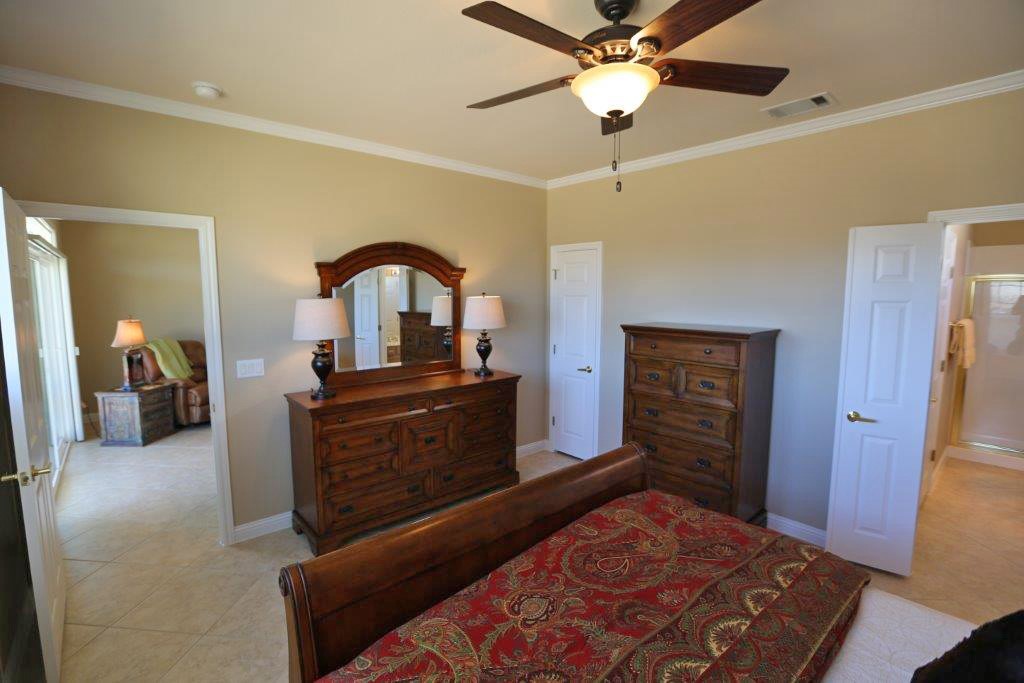 109 Ranier Lane Georgetown, TX 78633 - Photo 11 of 18 Well-lit and functional, this bedroom offers crown molding and a convenient ceiling fan.