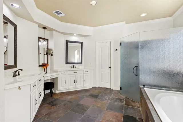 a spacious bathroom with a tub sink shower and mirror