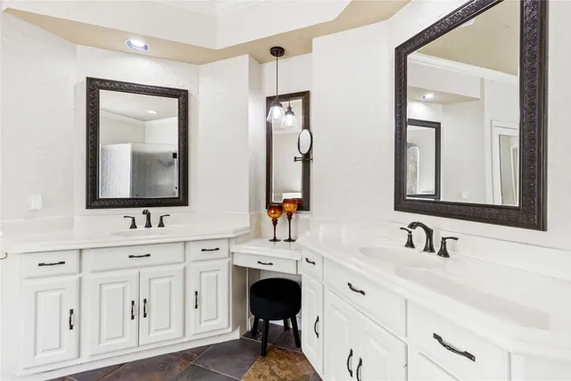 a bathroom with a double vanity sink and mirror