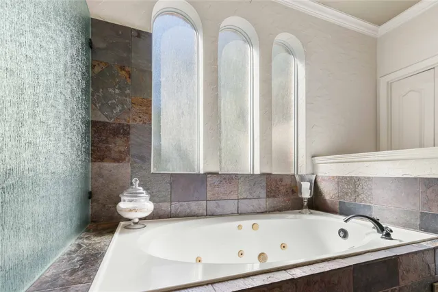 a bathroom with a bathtub and a window