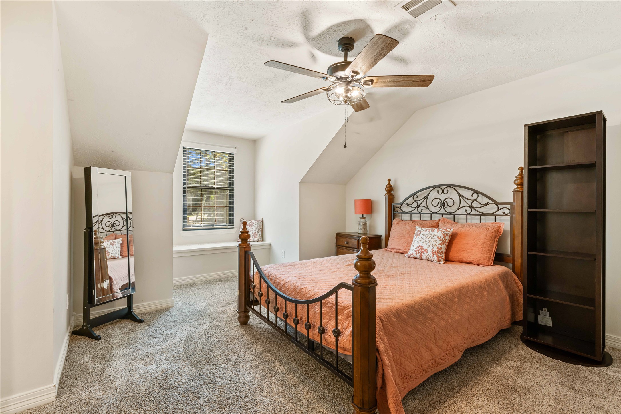 13322 Stonecrest Lane Conroe, TX 77302 - Photo 28 of 50 a bedroom with a bed and a chandelier