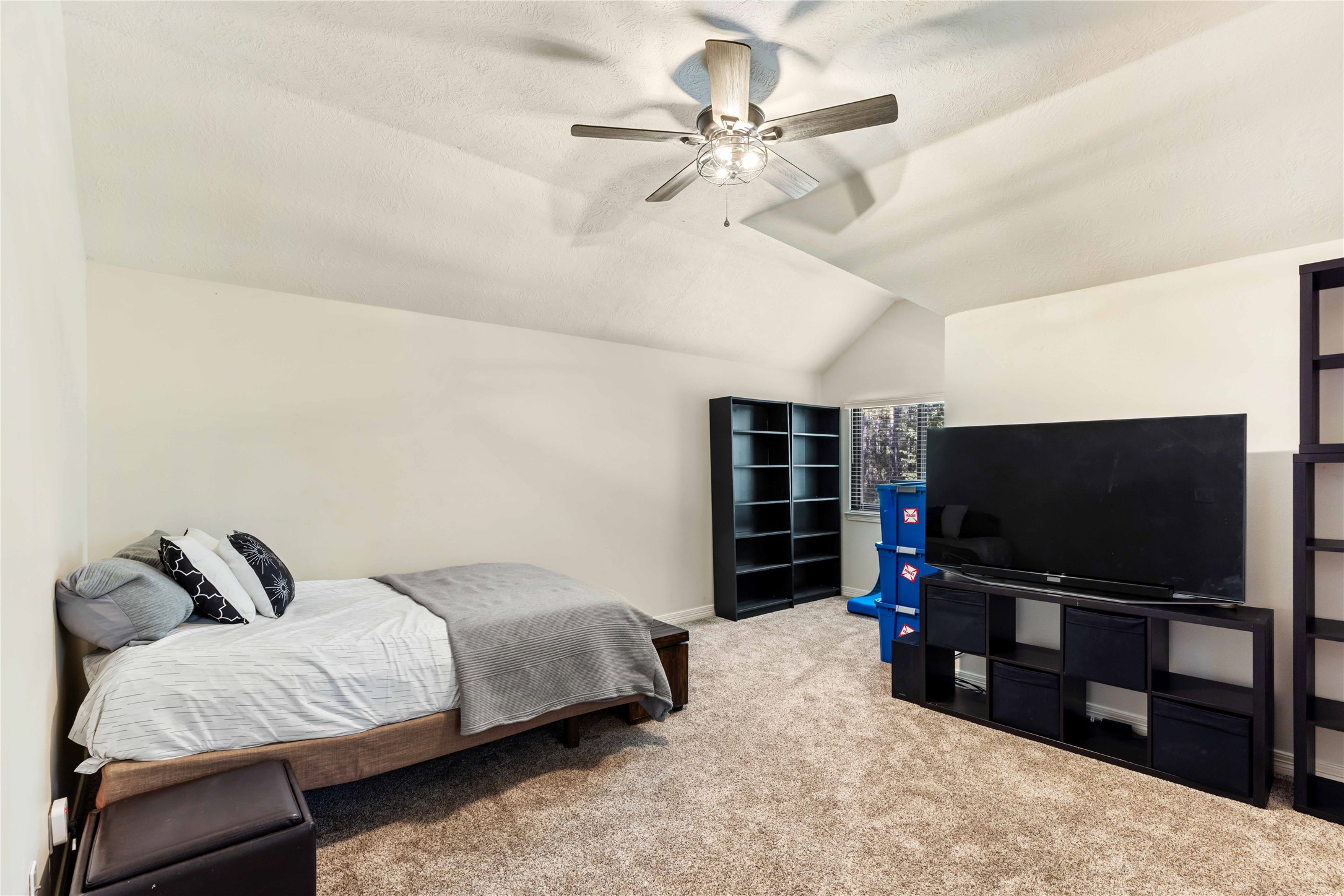 13322 Stonecrest Lane Conroe, TX 77302 - Photo 29 of 50 a living room with furniture and a flat screen tv