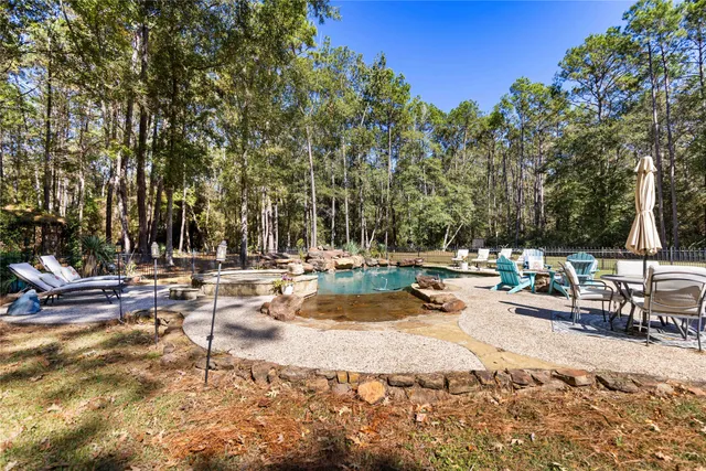 a view of swimming pool with sitting area and fire pit