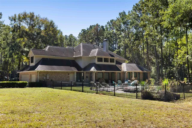 a front view of a house with swimming pool and patio