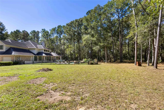 a swimming pool with outdoor seating and yard