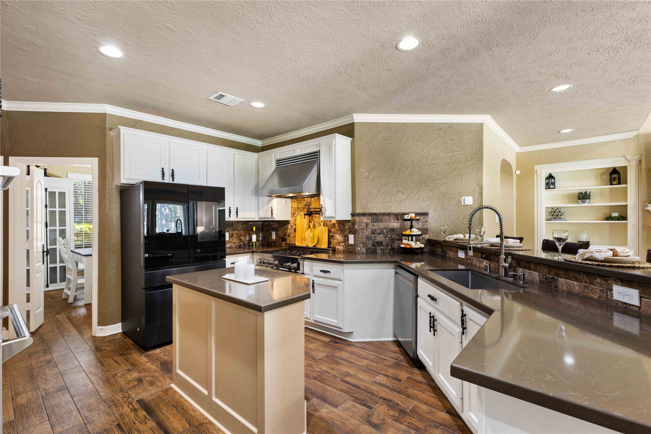 13322 Stonecrest Lane Conroe, TX 77302 - Photo 6 of 50 a kitchen with stainless steel appliances granite countertop a sink stove refrigerator and cabinets