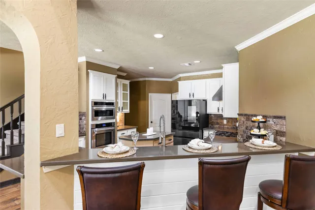 a kitchen with a sink appliances and cabinets